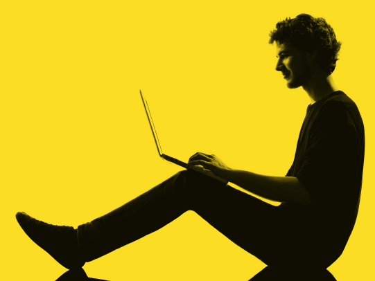 Image of a boy working on his laptop